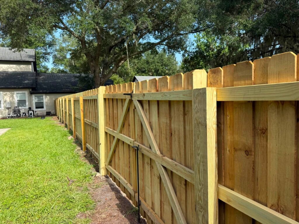 Pressure treated wood privacy fence with matching residential access gate