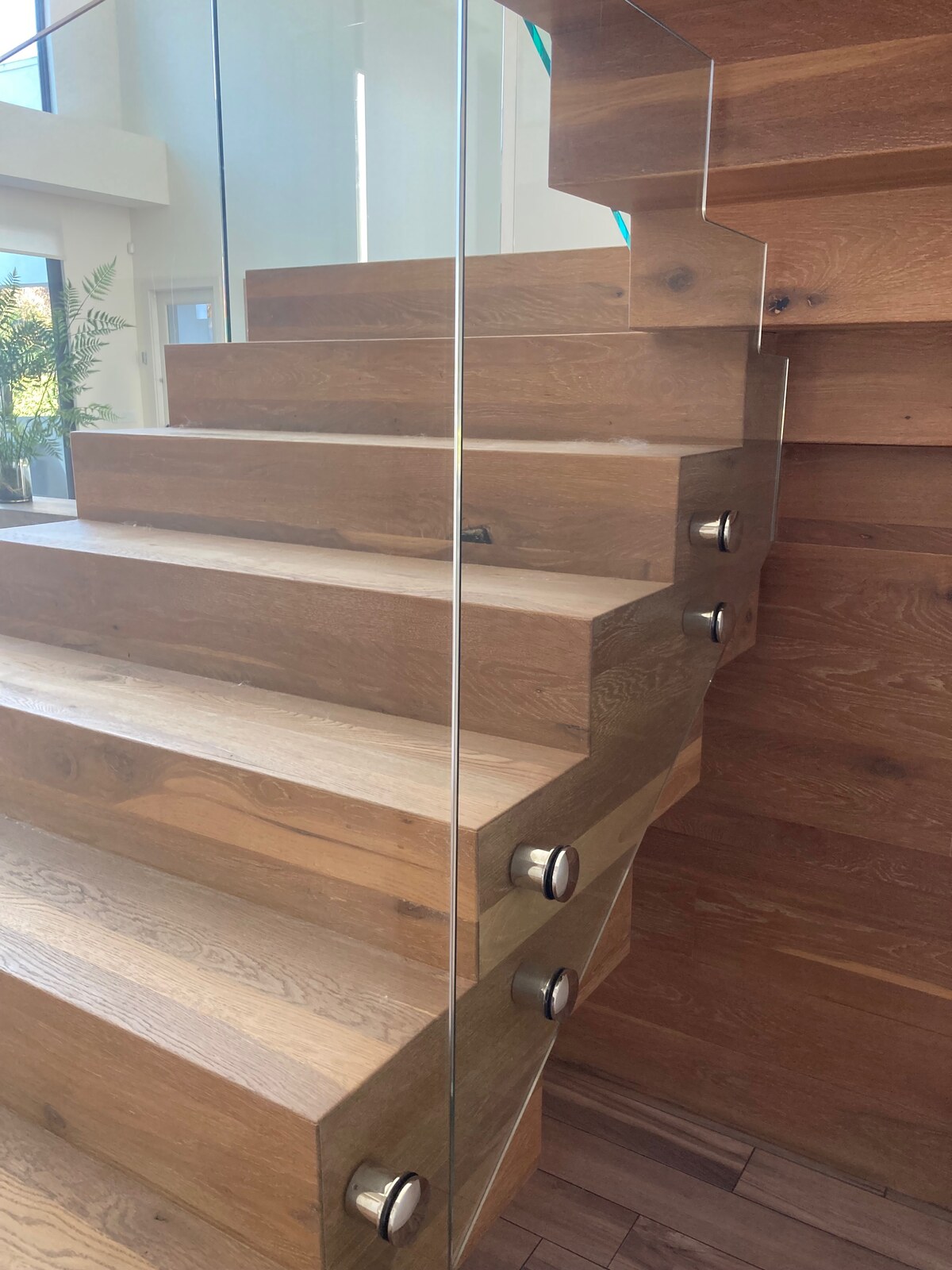 Custom interior glass stair railing installed by Elite