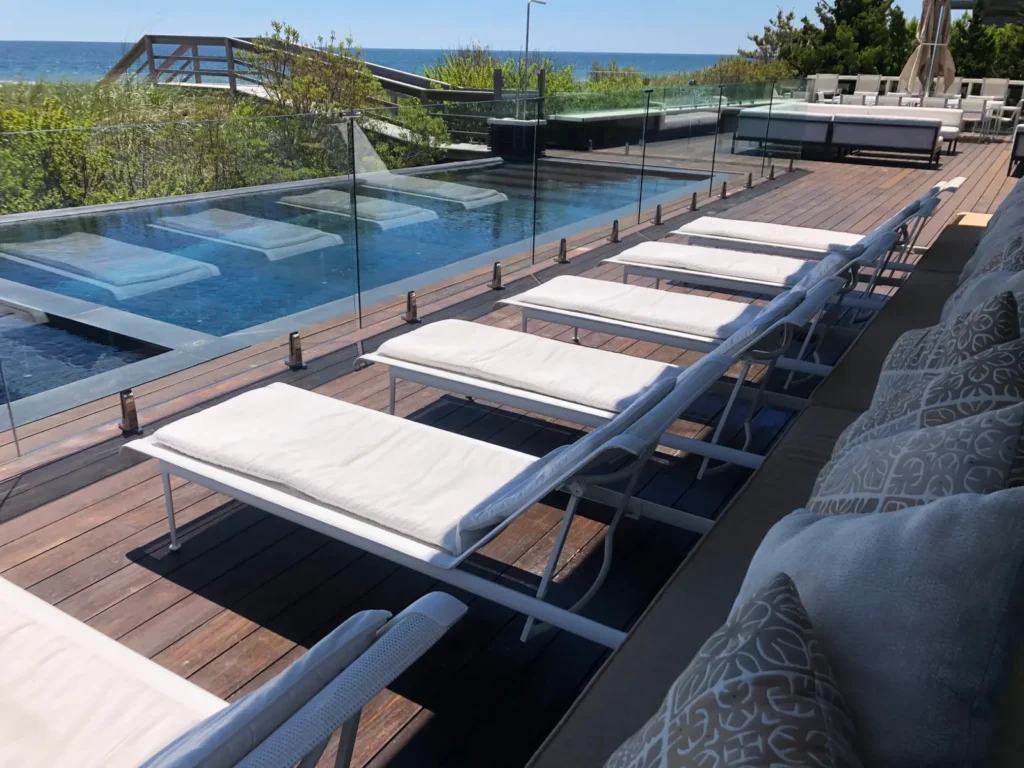 Oceanfront swimming pool protected by clear frameless glass fencing