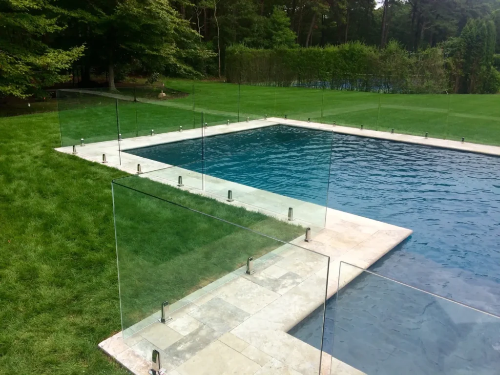 Residential swimming pool enclosed with frameless glass fencing